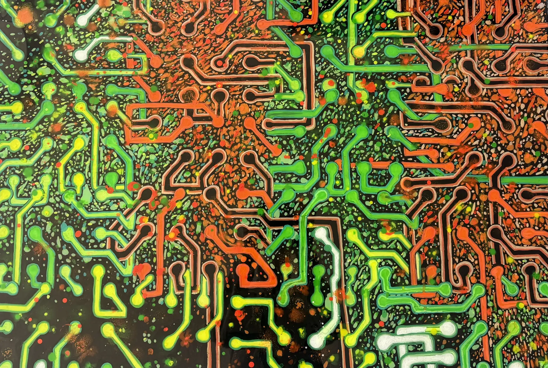 Living Circuit. Green circuit traces and orange cell growth laid over one another.